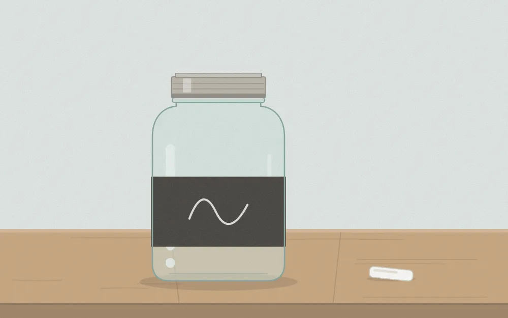 A jar with a matte black chalkboard-finish band around it and a chalk mark on the band