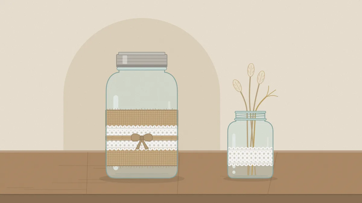 A clear quart jar with a wide burlap band and a narrower strip of white lace over it, tied with thin twine
