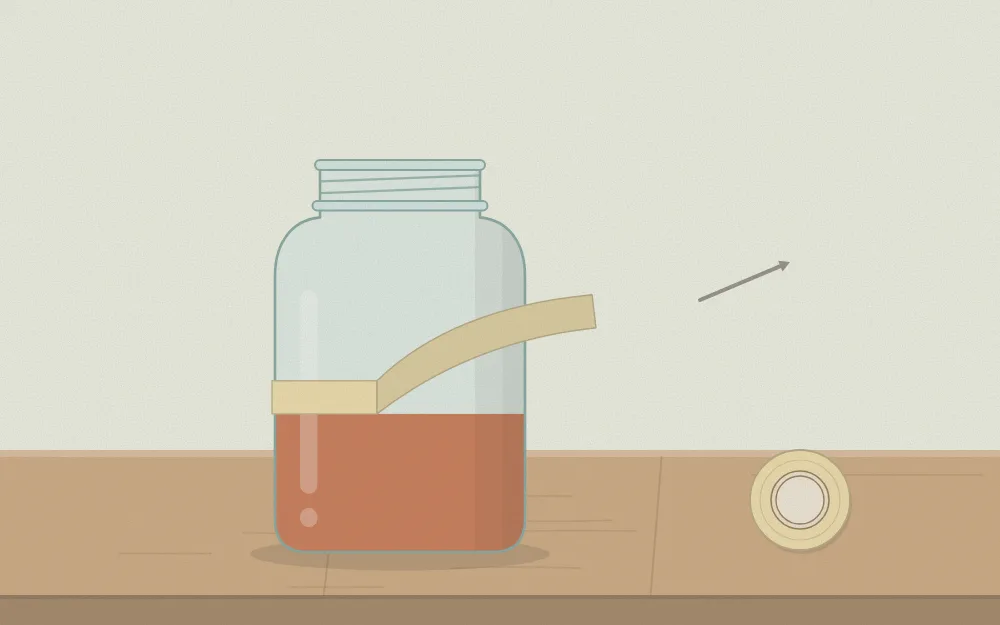 Tape being peeled away from a jar to reveal a clean, straight paint edge