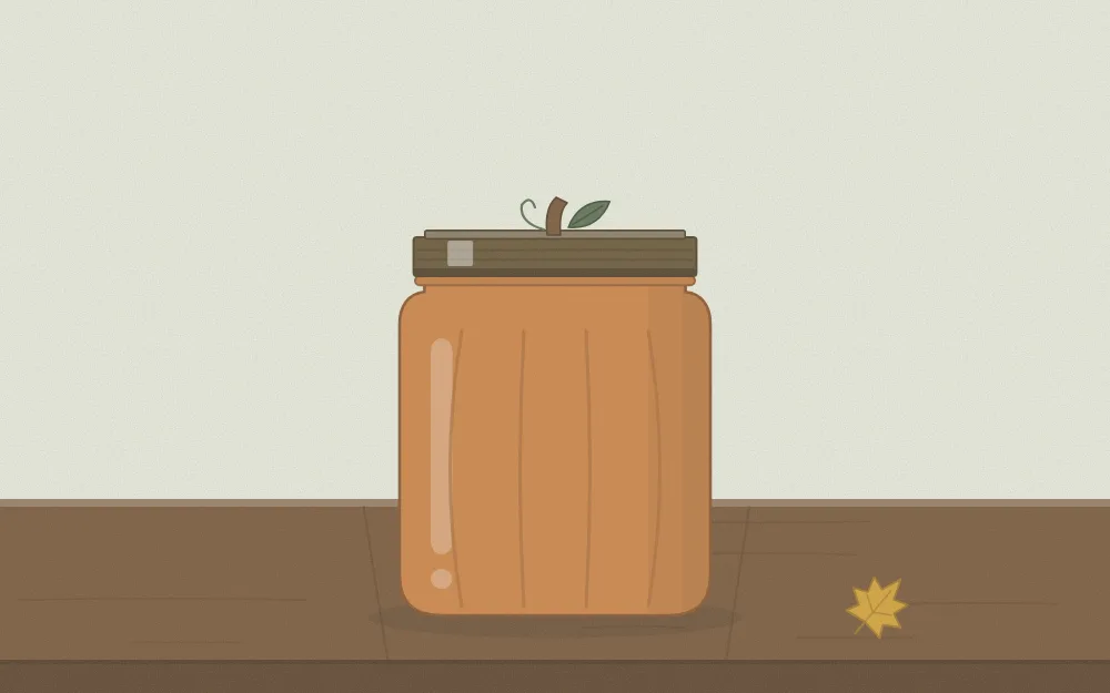 A jar painted muted orange with a short twig and a green leaf on the lid like a pumpkin