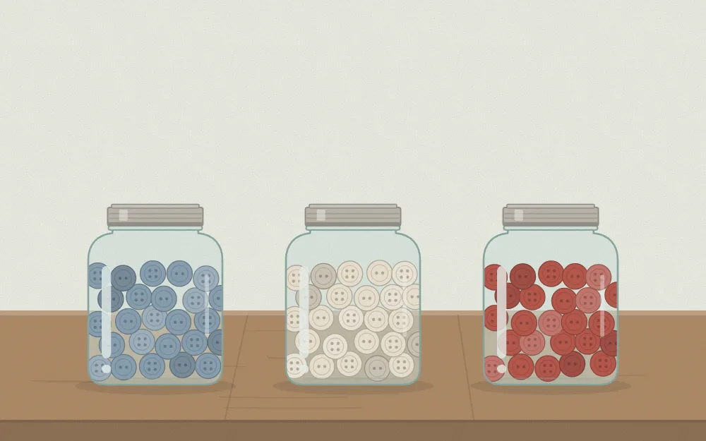 Three small jars with buttons sorted by color: one blue, one cream, one red