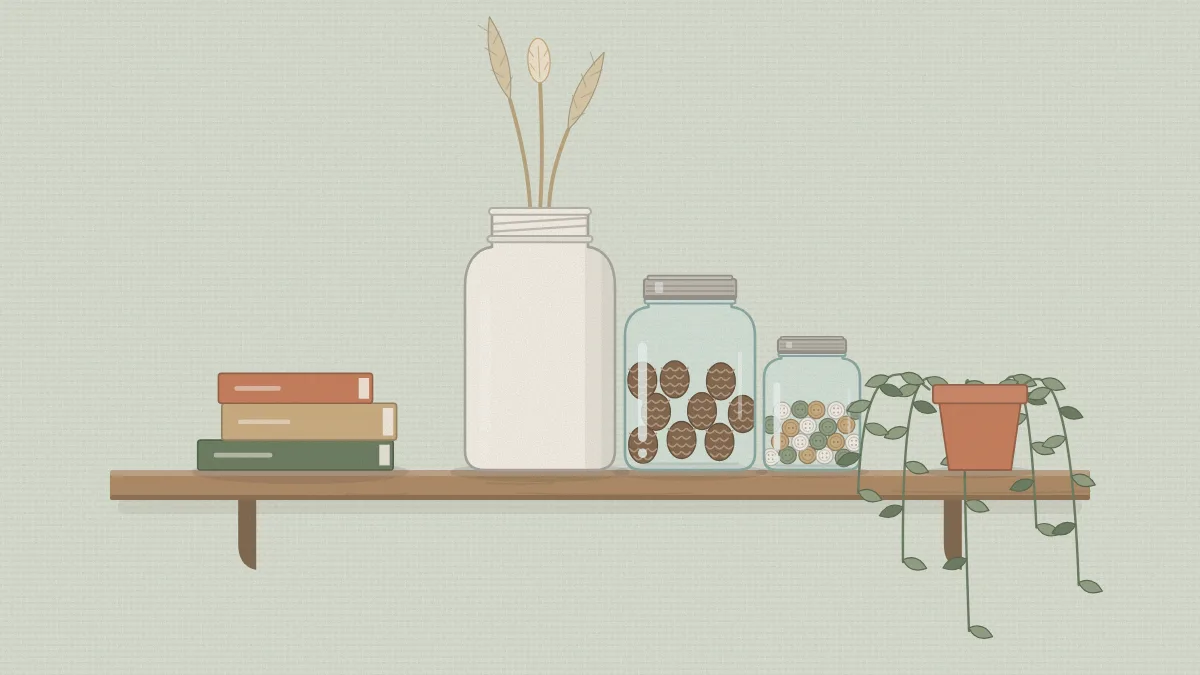 A wall shelf with a group of three jars, a small stack of books and a trailing plant